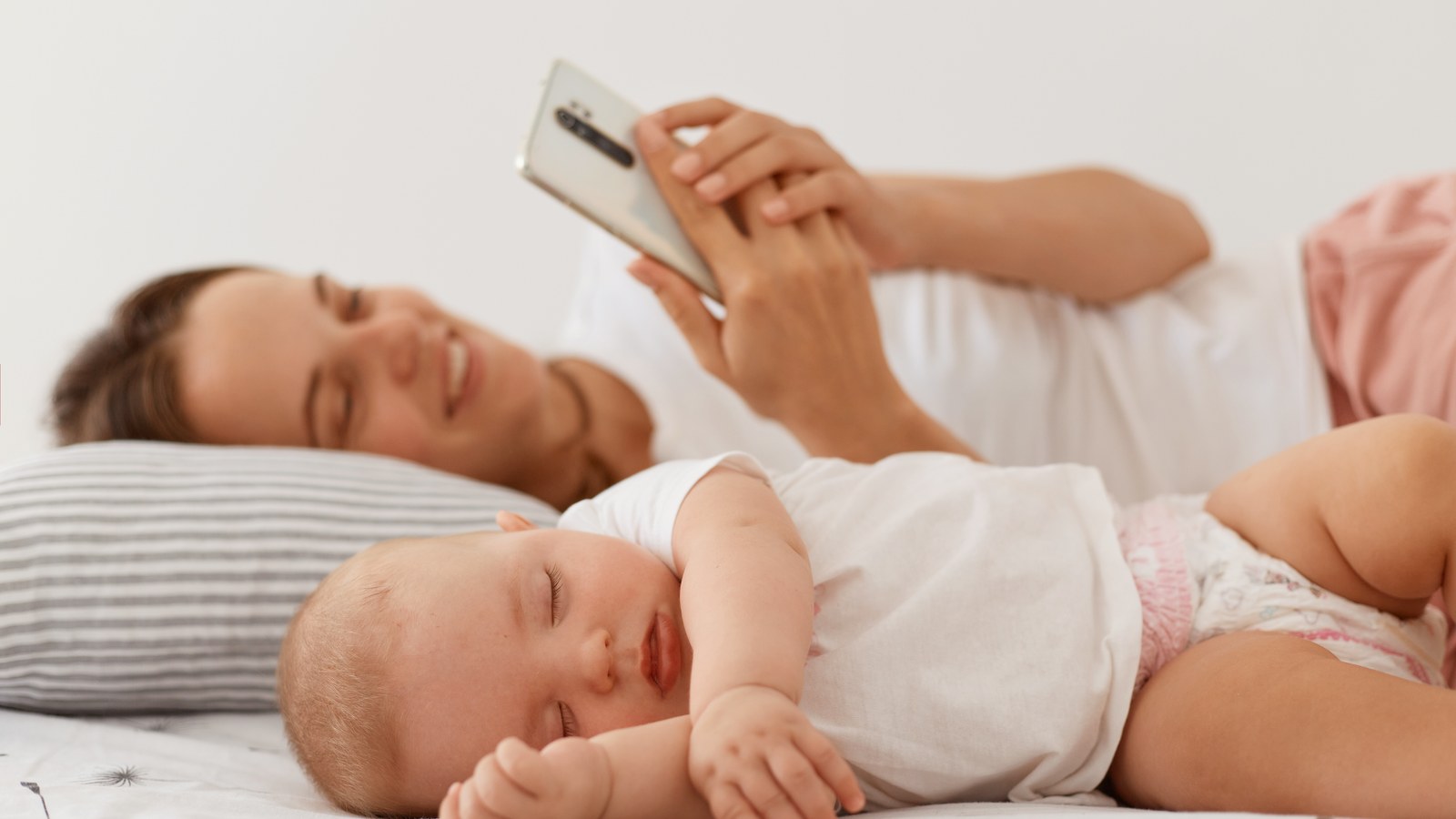 Owlet Cam hardware monitor compared side by side with a smartphone baby monitor app