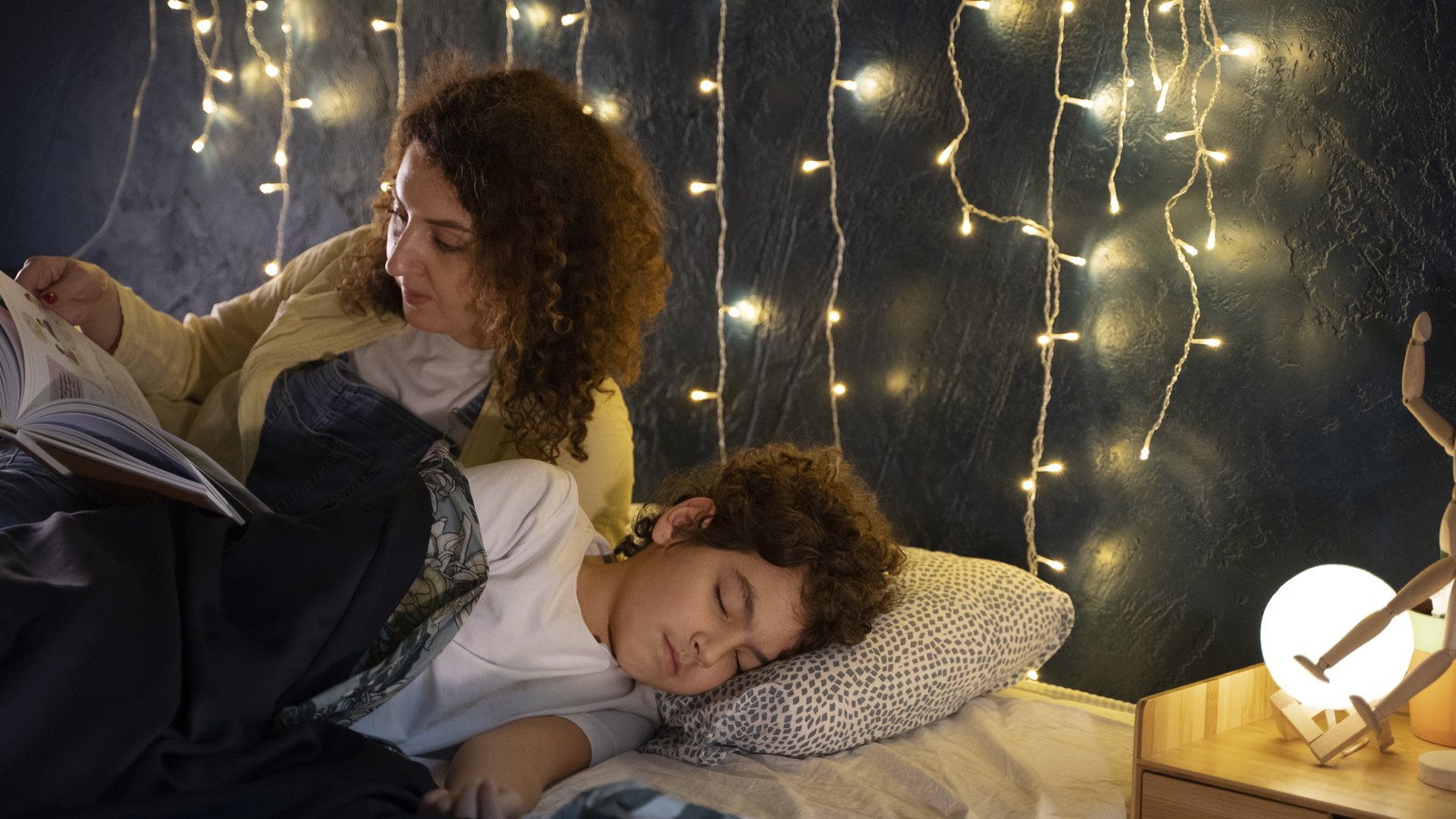 Parents tucking their child to sleep under gentle warm nursery nightlight glow
