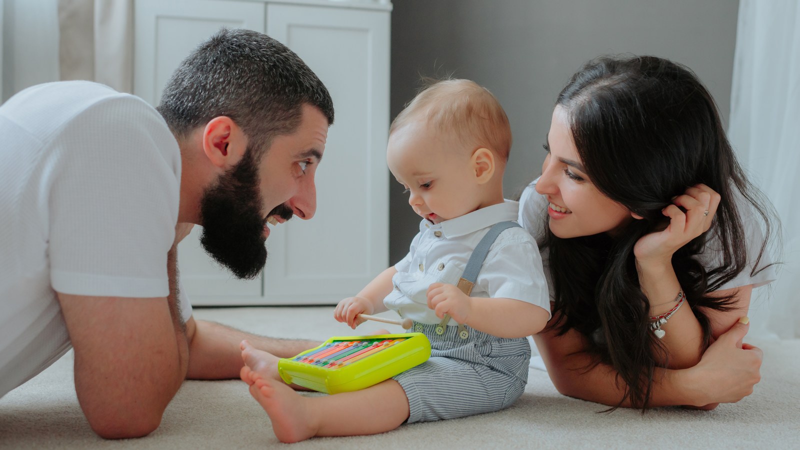 Expectant parents in a nursery evaluating whether they need a baby monitor