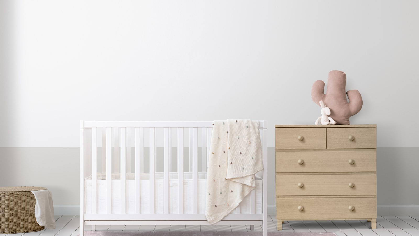 A clean, minimalist white wooden baby crib in a serene modern nursery room showing safe wall spacing.